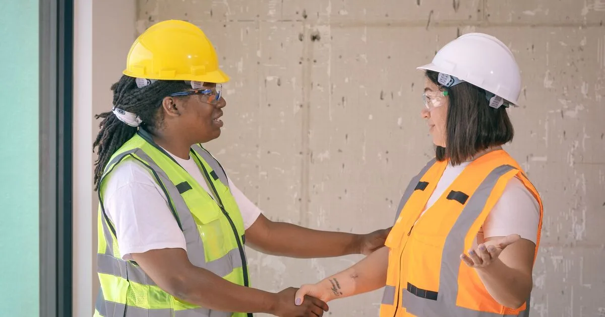 Two people shaking hands to seal an agreement outdoors